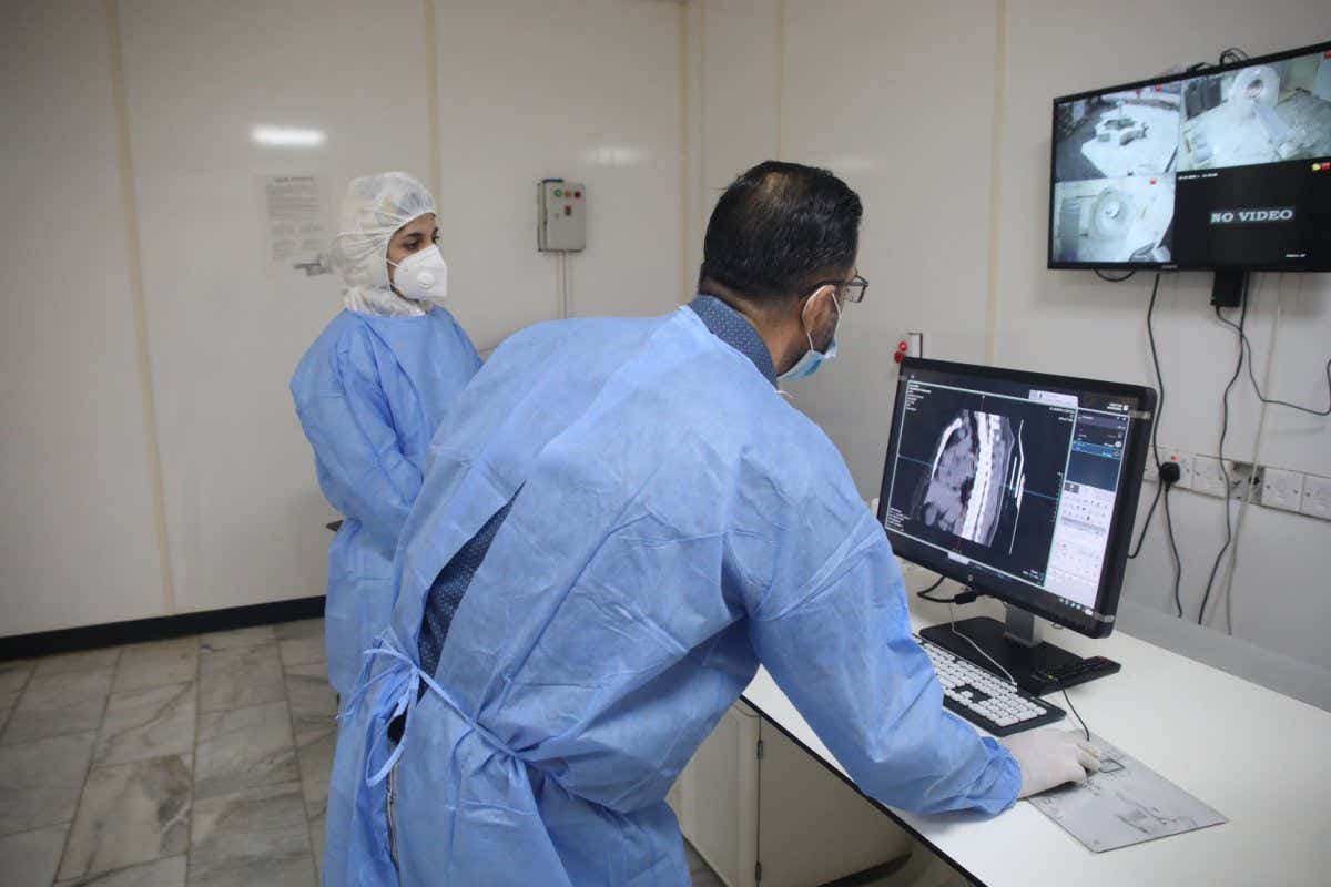 Mandatory Credit: Photo by CHINE NOUVELLE/SIPA/Shutterstock (10963111a) Dr. Mohammed Abdul-Hussein (R) and CT technician Hanan Jamal examine lung images at al-Shifaa Center in Baghdad, Iraq, Oct. 12, 2020. In a specialized COVID-19 hospital in Iraqi capital of Baghdad, a Chinese-donated CT scan, mobile X-ray equipment, and other medical supplies are saving lives in the front-line battle against the COVID-19 pandemic. Already 400 patients have benefited from the important medical donation. TO GO WITH 
