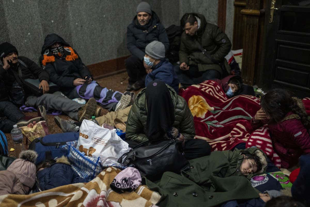 Mandatory Credit: Photo by Bernat Armangue/AP/Shutterstock (12826679g) Afghans trying to flee Ukraine sleep inside Lviv railway station, in Lviv, west Ukraine. Russia's military assault on Ukraine has entered its fifth day, forcing hundreds of thousands of Ukrainians and foreign residents to escape from war and seek refuge in neighboring countries Russia War, Lviv, Ukraine - 27 Feb 2022