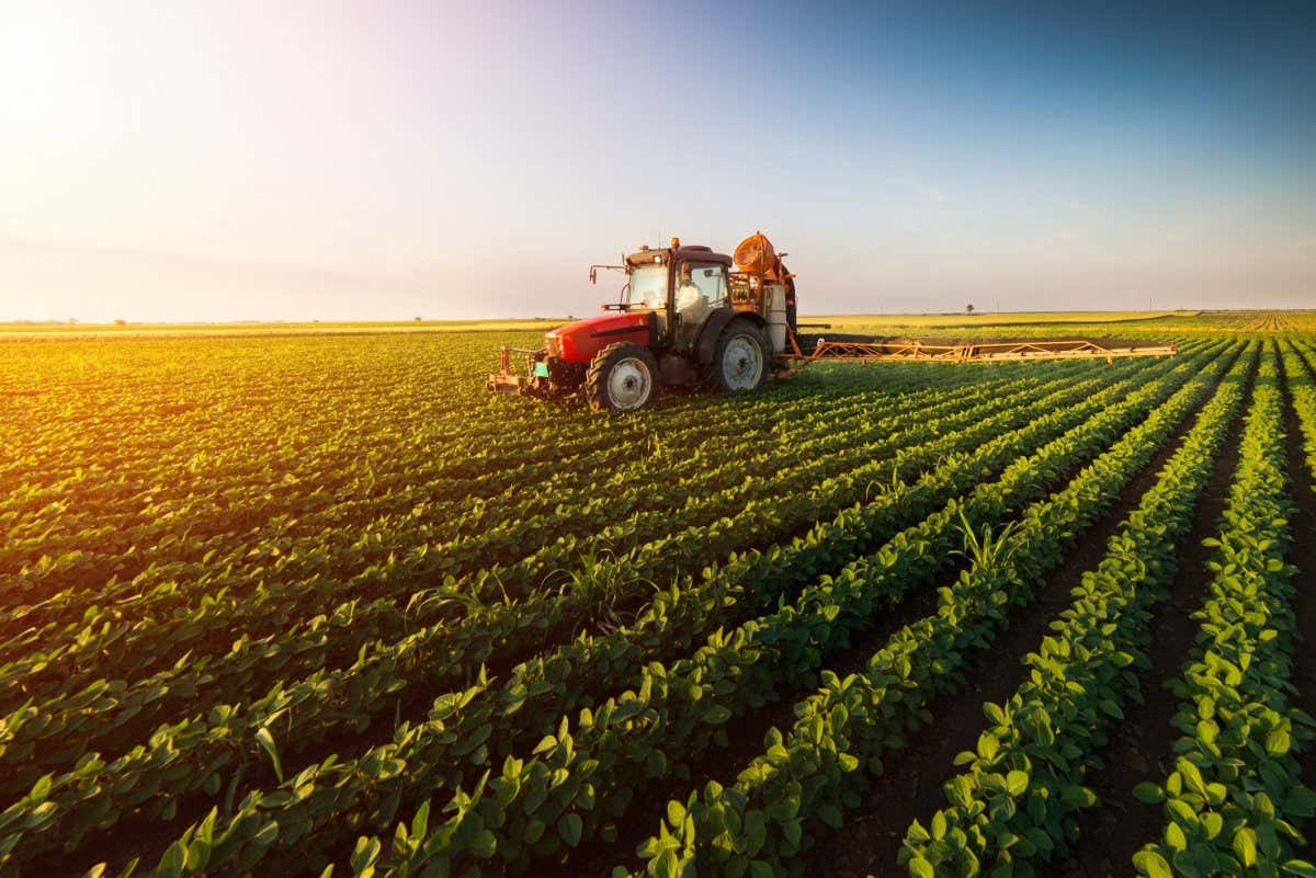 Tractor spraying pesticides on soybean field with sprayer at spring; Shutterstock ID 653708227; purchase_order: -; job: -; client: -; other: -