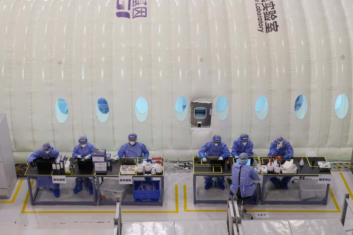 Mandatory Credit: Photo by Kin Cheung/AP/Shutterstock (12833050v) Health workers from mainland China work at the Huo-Yan (Fire Eye) Laboratory, an inflatable mobile testing lab in Hong Kong, . Hong Kong has ramped up its testing capacity with the help of inflatable mobile laboratories, as the city grapples with tens of thousands of COVID-19 cases daily Virus Outbreak , Hong Kong, Hong Kong - 04 Mar 2022
