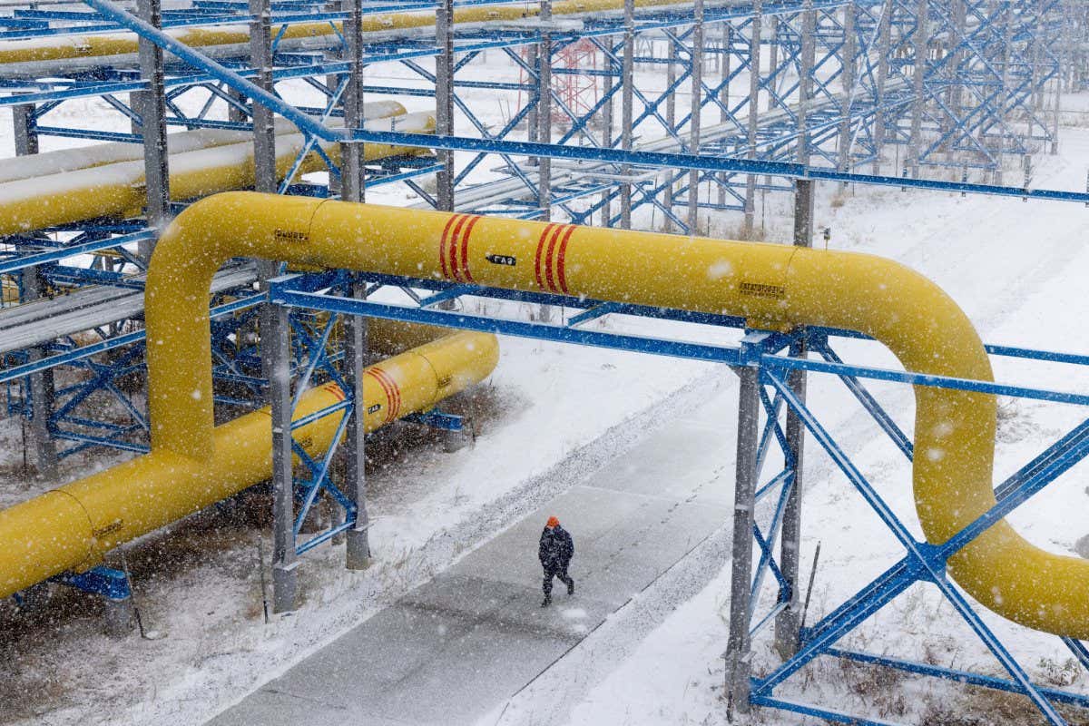 A worker walks under pipework in the yard at the Comprehensive Gas Treatment Unit No.3 of the Gazprom PJSC Chayandinskoye oil, gas and condensate field, a resource base for the Power of Siberia gas pipeline, in the Lensk district of the Sakha Republic, Russia, on Monday, Oct. 11, 2021. Amid record daily swings of as much as 40% in European gas prices, Russian President Vladimir Putin made a calculated intervention to cool the market last week by saying Gazprom can boost supplies to help ease shortages. Photographer: Andrey Rudakov/Bloomberg via Getty Images