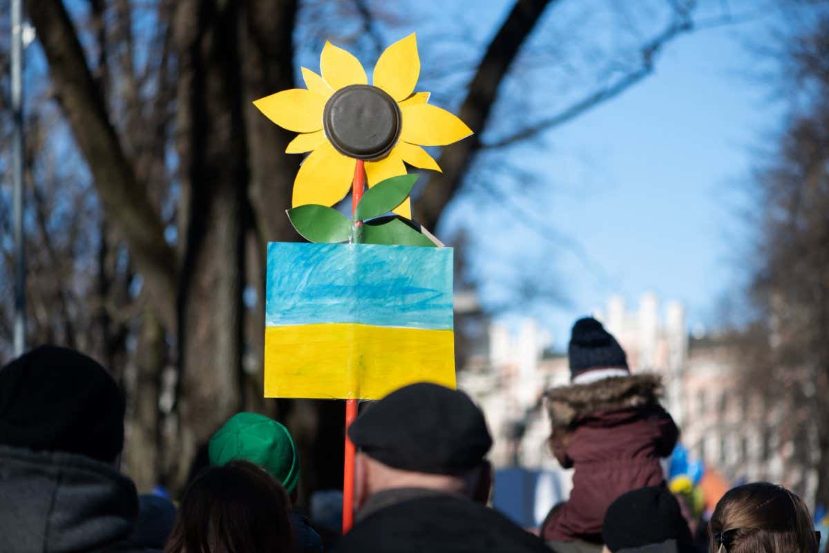 Riga, Latvia - March 05, 2022: Protest against war in Ukraine and Russia's invasion. Crowd of people with flags, signs and posters at demonstration in support of Ukraine to demand Putin to stop war.; Shutterstock ID 2132631761; purchase_order: -; job: -; client: -; other: -