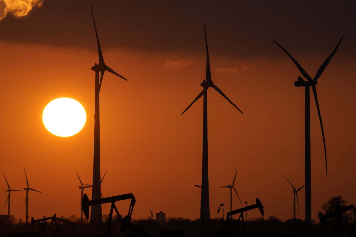 Mandatory Credit: Photo by Martin Meissner/AP/Shutterstock (12872560a) Wind turbines produce power during sundown in Emlichheim, Germany, . The head of the International Renewable Energy Agency says 