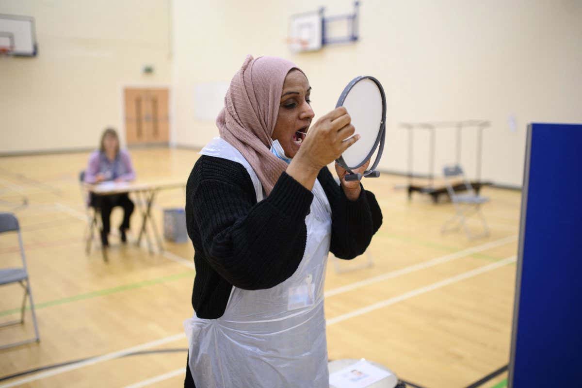 A staff member at a testing centre in Halifax, England, takes a covid-19 lateral flow test on 4 January