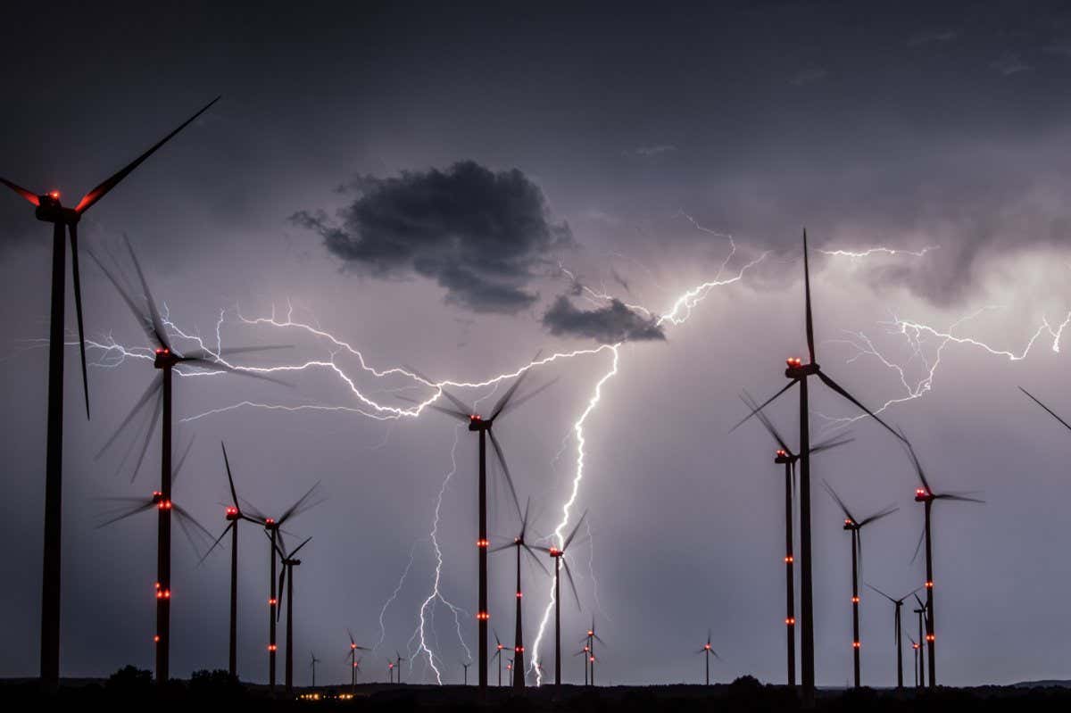 TOPSHOT - Lightnings flash over windmills of the Odervorland wind energy park near Sieversdorf, eastern Germany, on August 1, 2017. / AFP PHOTO / dpa / Patrick Pleul / Germany OUT (Photo credit should read PATRICK PLEUL/DPA/AFP via Getty Images)
