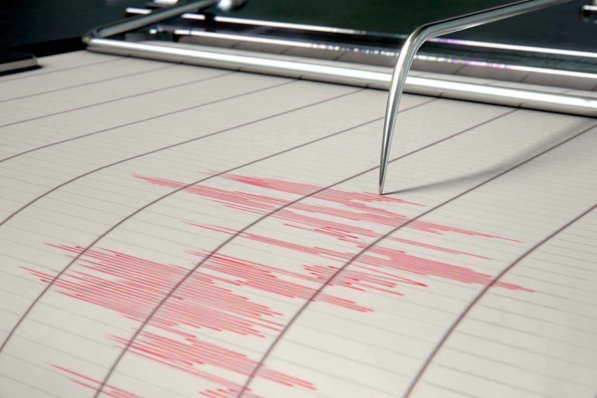 A closeup of a seismograph machine needle drawing a red line on graph paper depicting seismic and earthquake activity - 3D render; Shutterstock ID 714451717; purchase_order: -; job: -; client: -; other: -