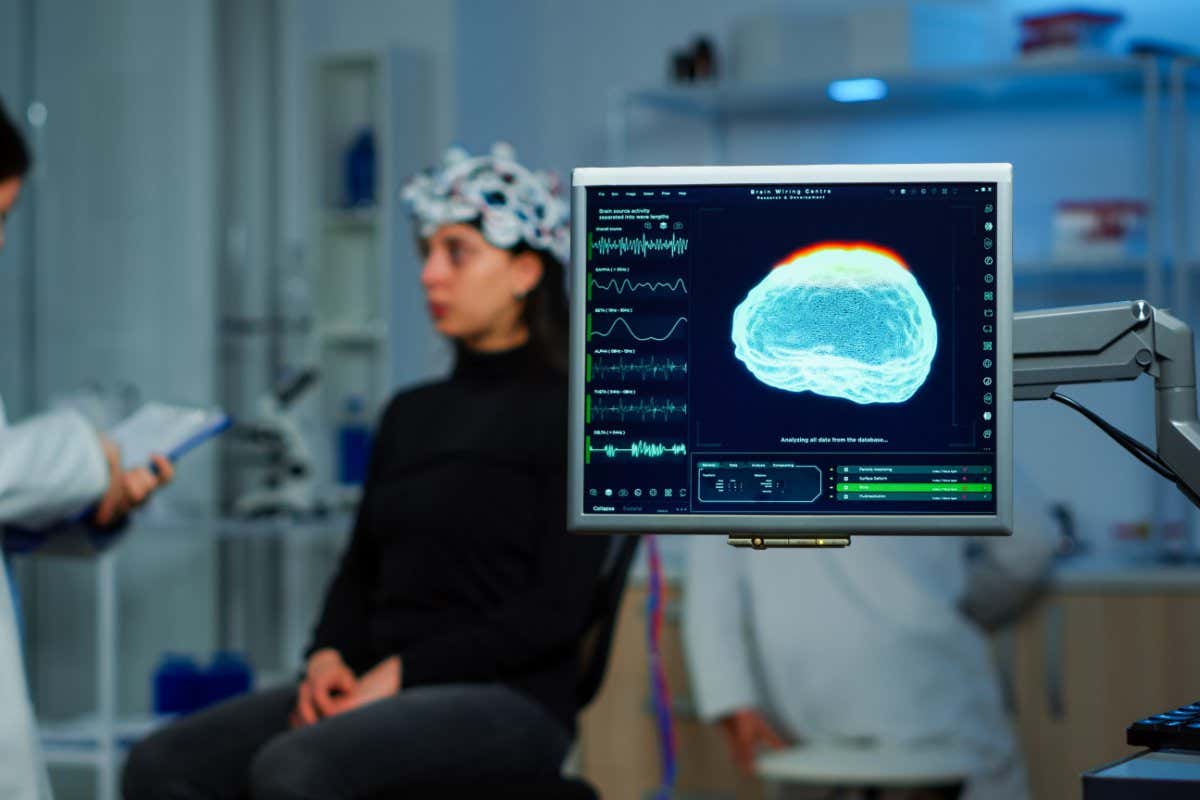 Neurologist doctor analysing nervous system using eeg headset scanning woman brain. Scientist researcher using high tech developing neurological innovation, monitoring side effects on monitor screen; Shutterstock ID 1955759332; purchase_order: -; job: -; client: -; other: -