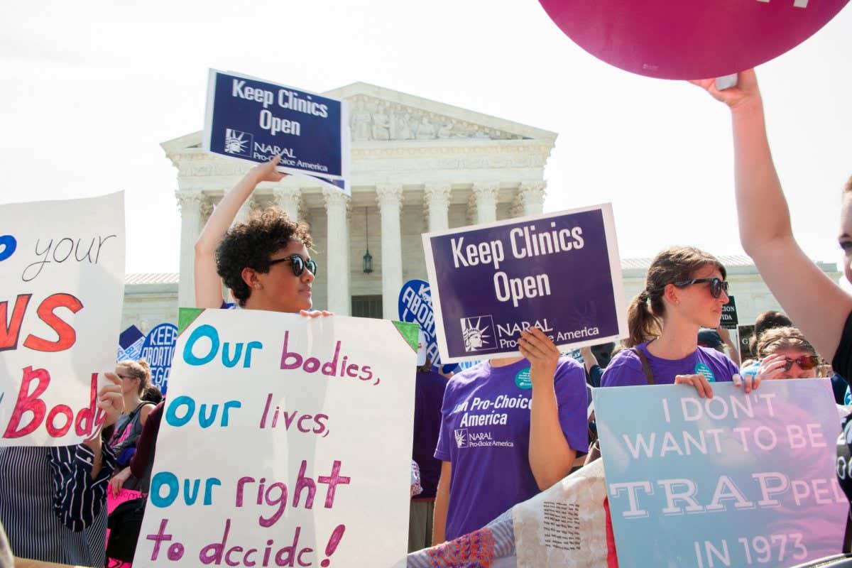 WASHINGTON JUNE 27: A pro-choice activist holds a Planned Parenthood sign while awaiting the Supreme Court???s ruling on abortion access in front of the Supreme Court in Washington, DC on June 27, 2016; Shutterstock ID 443763643; purchase_order: NS online; job: Photo; client: NS; other: