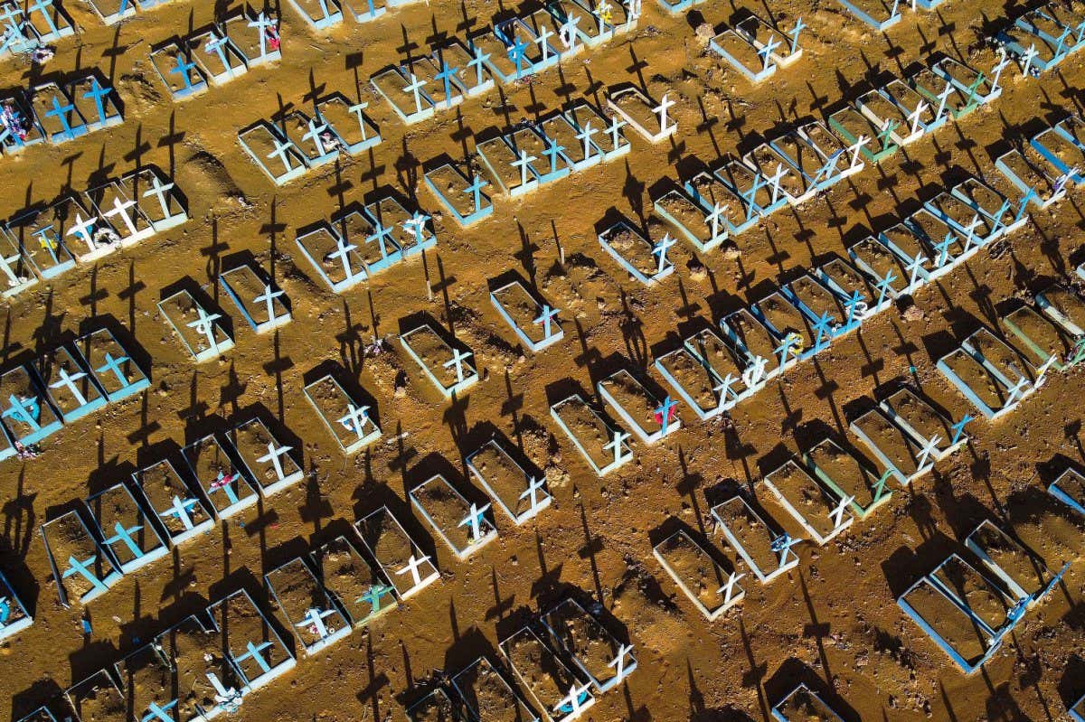 An aerial view of a burial site for people who died with covid-19 at the Nossa Senhora Aparecida cemetery in Manaus, in the Amazon forest in Brazil, taken on 21 November 2020