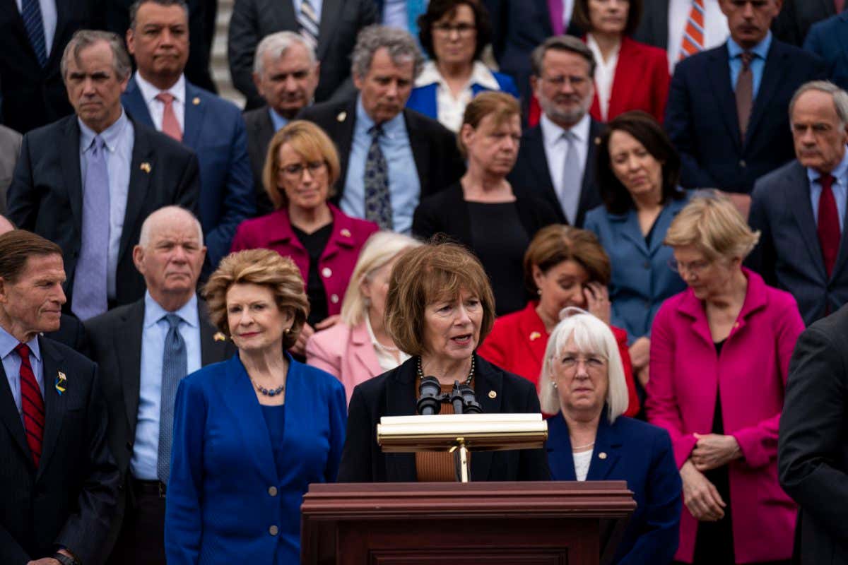 WASHINGTON, DC - MAY 03: Sen. Tina Smith (D-MN) speaks as other Senate Democrats listen during a news conference about the leaked Supreme Court draft decision to overturn Roe v. Wade on the steps of the Senate on Tuesday, May 3, 2022 in Washington, DC. In a leaked initial draft majority opinion obtained and published by Politico, and authenticated by Supreme Court Chief Justice John Roberts Supreme Court Justice Samuel Alito wrote that the cases Roe v. Wade and Planned Parenthood of Southeastern Pennsylvania v. Casey should be overturned, which would end federal protection of abortion rights across the country. (Kent Nishimura / Los Angeles Times via Getty Images)