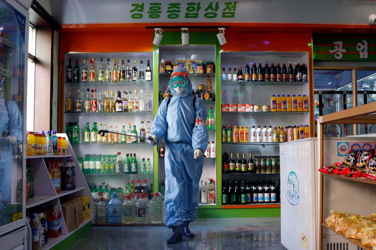 An employee disinfects a supermarket in Pyongyang, North Korea in November 2021