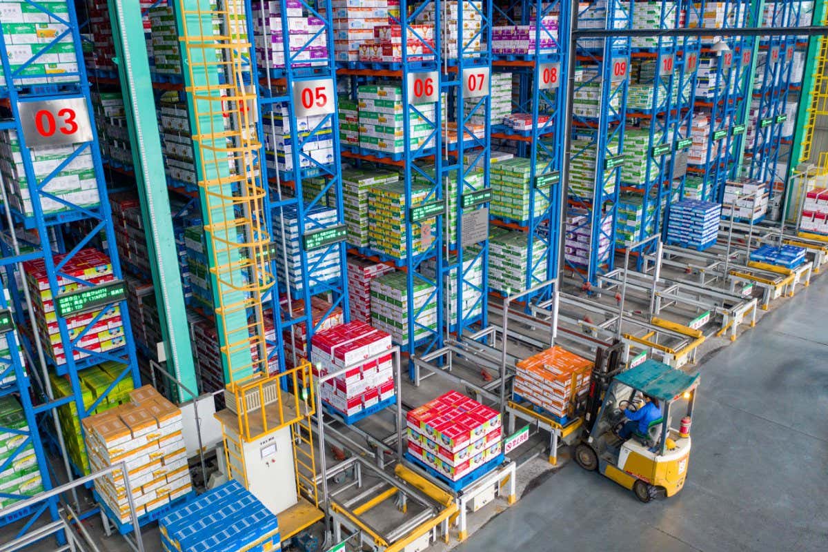 HEFEI, CHINA - OCTOBER 09: An employee arranges boxes of agricultural chemicals at an intelligent warehouse of Anhui Fengle Agrochemical Co., Ltd on October 9, 2021 in Hefei, Anhui Province of China. (Photo by Ruan Xuefeng/VCG via Getty Images)