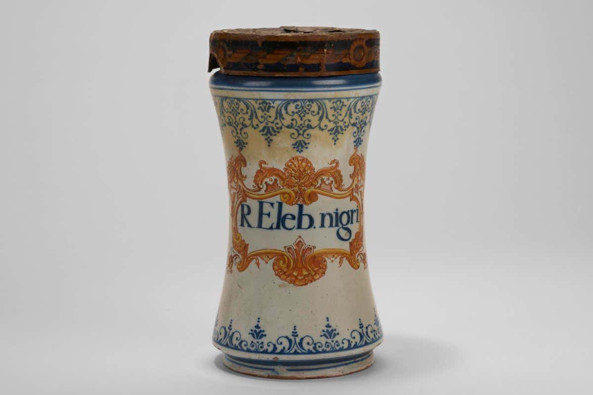 Tin-glazed earthenware albarello, complete with parchment lid, blue and yellow decoration, labelled 