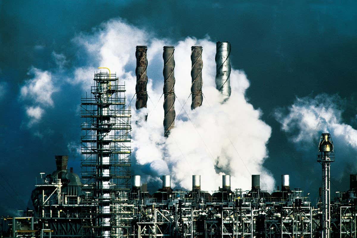A stock image of smoke and steam being emitted from an industrial plant