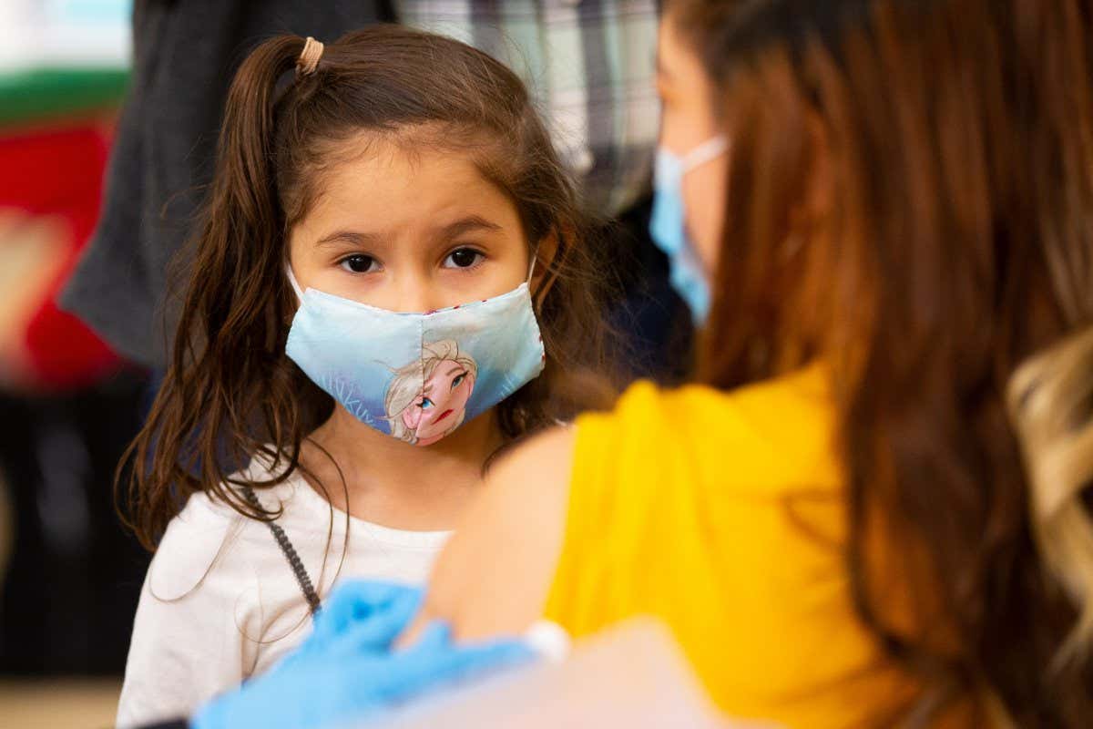 Mandatory Credit: Photo by CJ GUNTHER/EPFive year old Brittany Siguenza watches as her mother receives a dose of the Moderna Covid-19 vaccine during a vaccine clinic for teachers and school administrators at the Rumney March Academy, in Revere, Massachusetts, USA