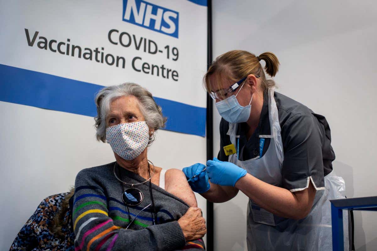 A person receives the first of two Pfizer/BioNTech covid-19 vaccines at Guy's Hospital in London, England, in December 2020