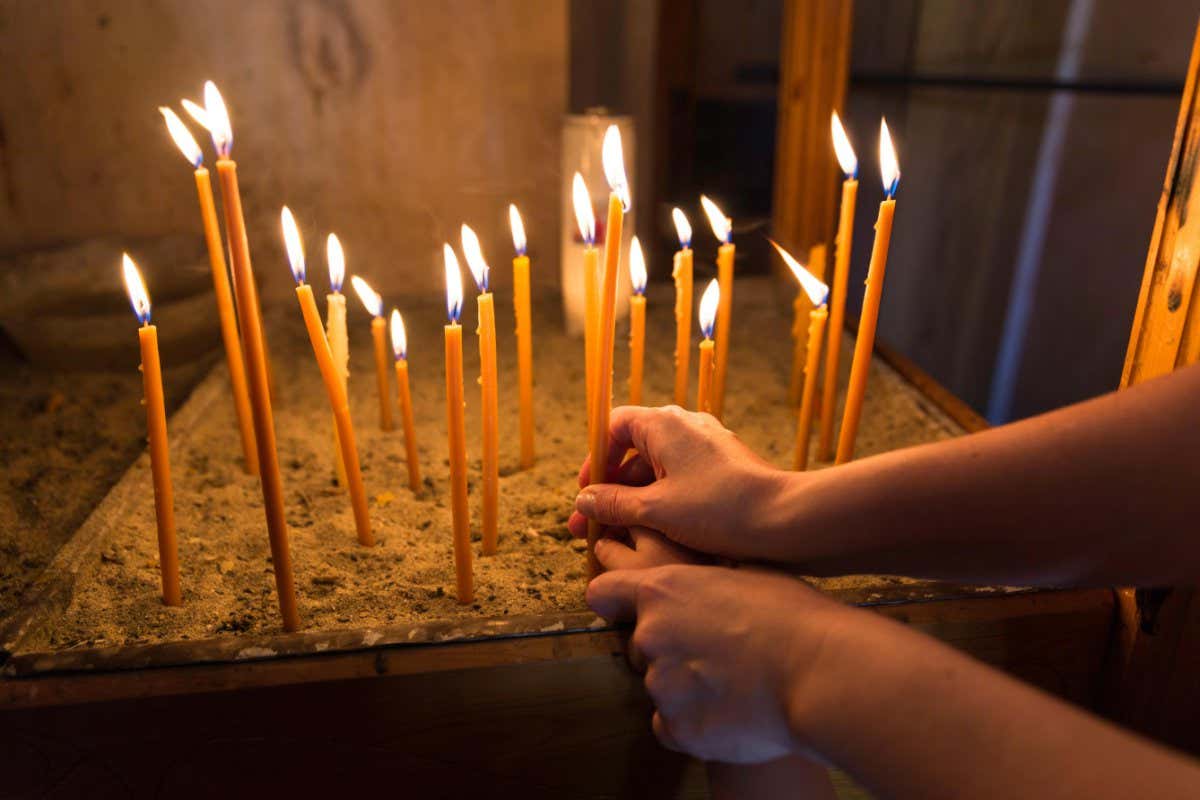 GPABM3 Mother and child lighting and holding a candle in Orthodox Church