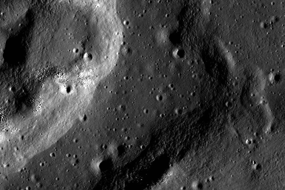 Mare Crisium is a large, dark, basaltic plain on the Moon that filled an ancient asteroid impact. Basaltic plains on the Moon were created by early volcanic eruptions. Mare Crisium was flooded with basaltic lava, a dark, runny lava commonly found on Earth. Basaltic plains on the Moon are also known as lunar maria, because of a mistaken belief by early astronomers that these dark areas were oceans ? ?maria? is the Latin word for ?seas.? We now know these spots to be plains of basalt created by early volcanic eruptions, but the nomenclature of ?maria? (plural) or ?mare? (singular) remains. The basalts in Mare Crisium range in age from 2.5 to 3.3 billion years old! These dates come from measuring the radioactive isotope signatures of samples returned from Mare Crisium by the Soviet Luna 24 mission. Along the rim of Mare Crisium lies an outer boundary of wrinkle ridges. Wrinkle ridges are commonly found in places where the surface has contracted. As the surface is compressed, it bends and fractures, and can form complicated patterns of faults and folds.