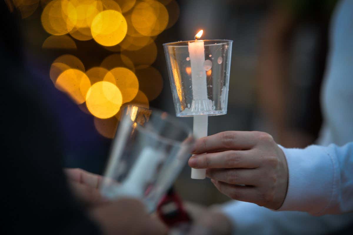 Participants light candles ahead of the sixth annual Bridge Of Life Suicide Awareness/Prevention candlelight vigil organised by YEG Mental Health, a group dedicated to raising awareness about mental health issues in the greater Edmonton area. On Friday, September 10, 2021, in Edmonton, Alberta, Canada. (Photo by Artur Widak/NurPhoto via Getty Images)