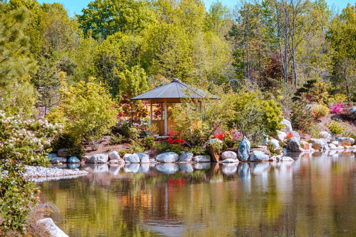 Grand Rapids Michigan / USA - May 22nd 2016: Landscape shot of a gazebo along the pond in the japanese garden at the Frederik Meijer Gardens in Grand Rapids Michigan; Shutterstock ID 1291751014; purchase_order: -; job: -; client: -; other: -