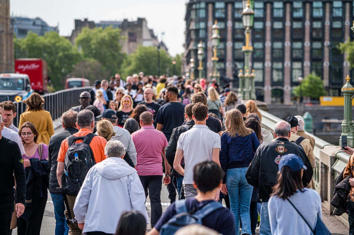 People walking along Westminster Bridge in London in May
