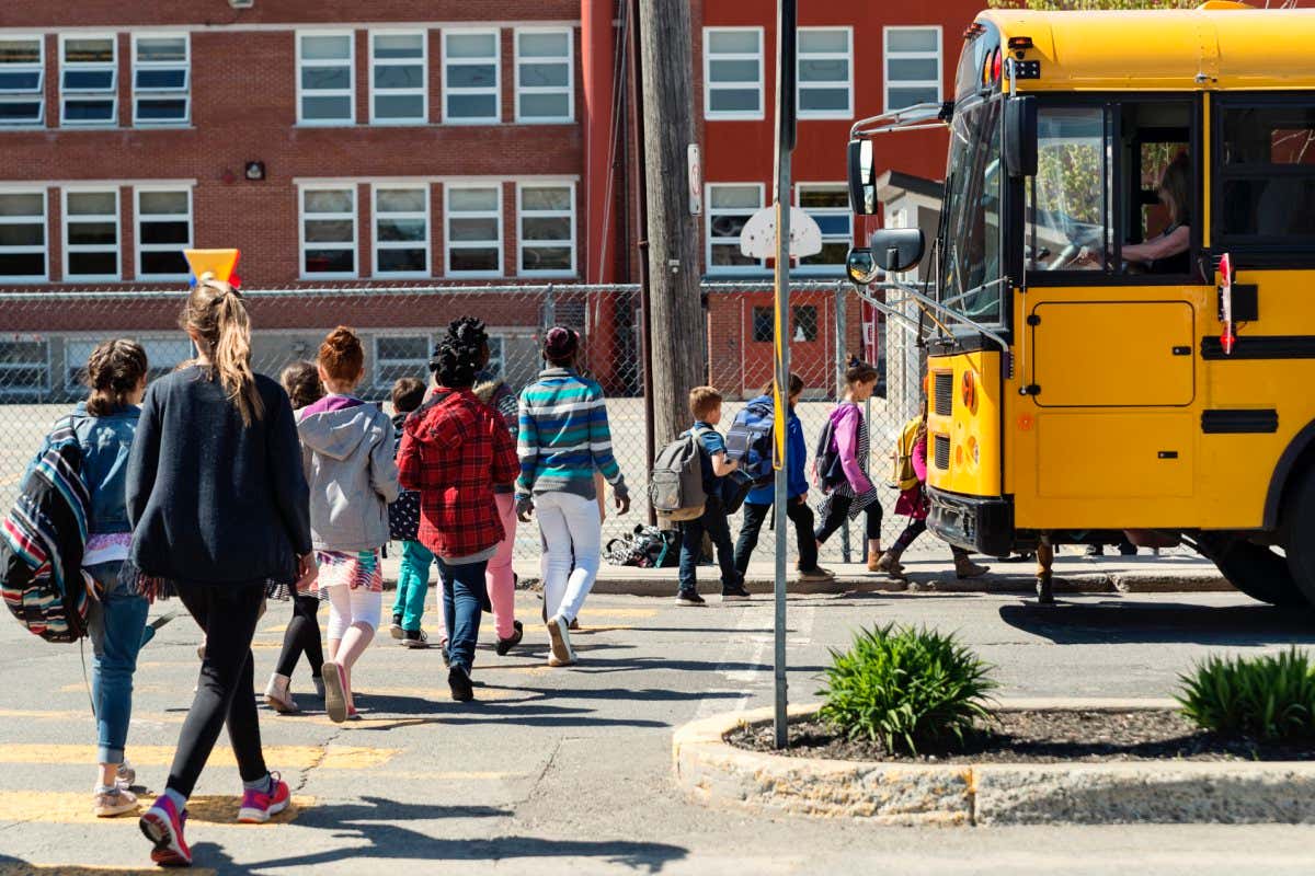 A stock image of children walking into school