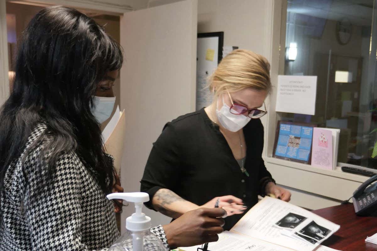 An employee looks over a patient's file at the Hope Medical Group for Women in Shreveport, Louisiana, April 19, 2022. - On September 1, 2021, one of the most restrictive anti-abortion laws in the country went into effect in the Republican state of Texas, prohibiting all voluntary termination of pregnancy (abortion) from the time a fetal heartbeat is visible on ultrasound, about four weeks after fertilization. With a population of 30 million, Texas is the second most populous state in the country and this law has driven patients to the rapidly overflowing clinics of other states, forcing them to inexorably delay their abortion due to lack of space. (Photo by Fran??ois Picard / AFP) (Photo by FRANCOIS PICARD/AFP via Getty Images)