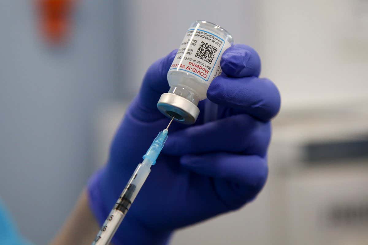 A Moderna covid-19 vaccine is prepared
