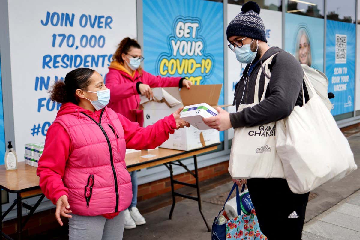 A person collects a covid-19 lateral flow test kit in London in December 2021