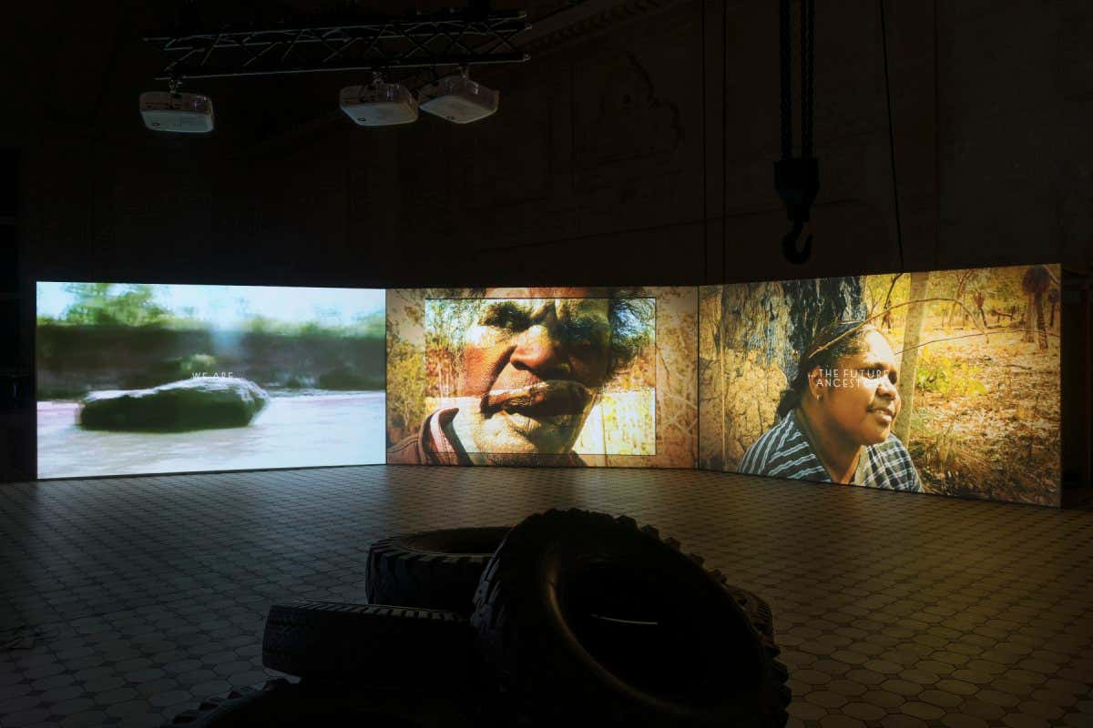 Installation view of The Family (A Zombie Movie) by Karrabing Film Collective, as part of POWER NIGHTS curated by Lucia Pietroiusti at E-WERK Luckenwalde, 2021 - 2022. Courtesy E-WERK Luckenwalde and Karrabing Film Collective. Image: Stefan Korte.