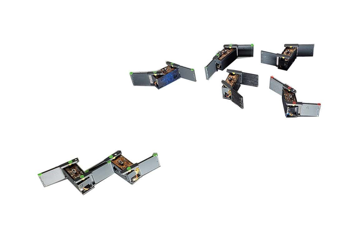 Tiny robots shaped like jiggling staples can form structures that help them move more easily even when they are programmed to push each other away.