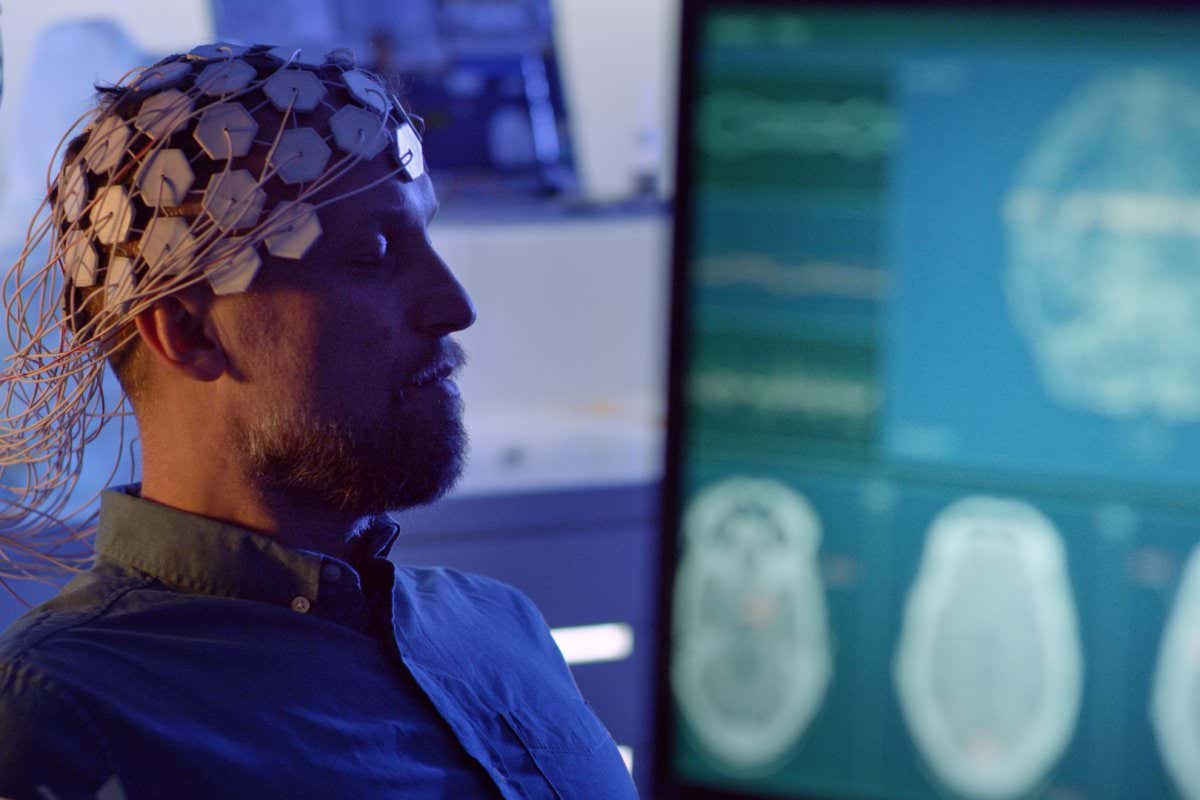 Man wearing an EEG cap to record brainwaves