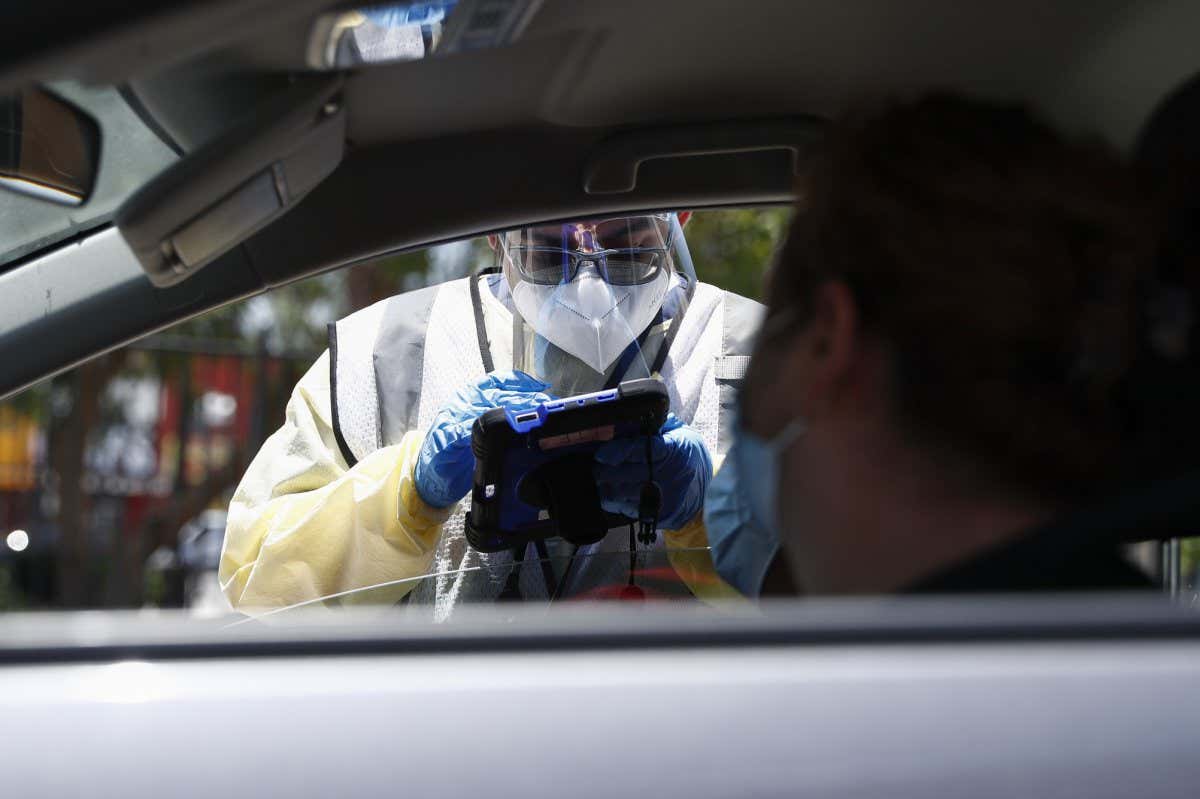 Mandatory Credit: Photo by CAROLINE BREHMAN/EPA-EFE/Shutterstock (13023803f) Healthcare worker Jesus Eduardo Lara, collects information before taking a nasal swab sample to test for Covid-19, at a Total Testing Solutions Covid Testing Center in Los Angeles, California, USA, 08 July 2022. Covid-19 positive patients in Los Angeles County hospitals has risen to over 1000 people since 02 July, as highly contagious variants of the virus take hold. Los Angeles County Covid-19 hospitalizations surge, USA - 08 Jul 2022