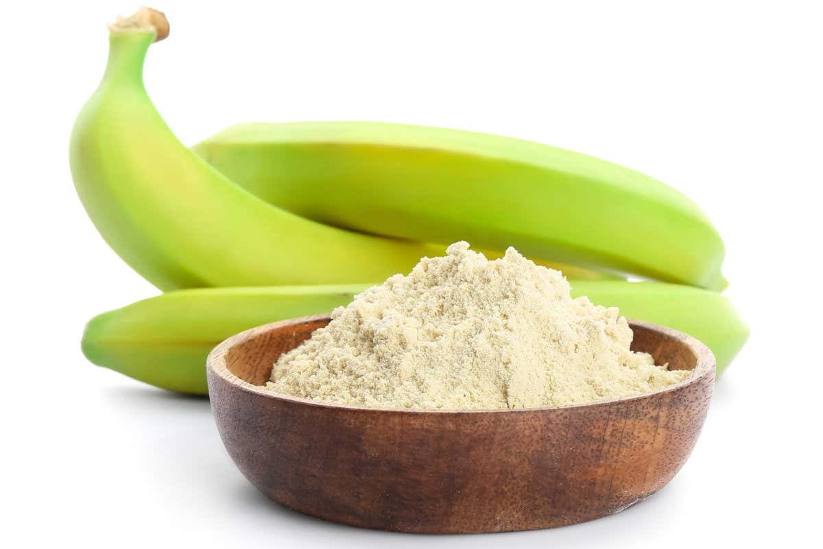 Tasty bananas and bowl with flour on white background; Shutterstock ID 2021919308; purchase_order: -; job: -; client: -; other: -