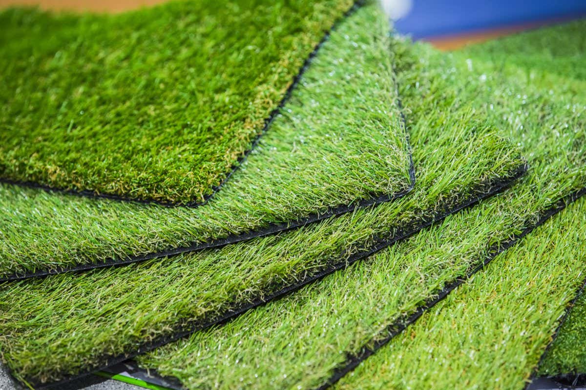 Green artificial turf rolled. Probes examples of artificial turf, floor coverings for playgrounds.; Shutterstock ID 712607011; purchase_order: -; job: -; client: -; other: -