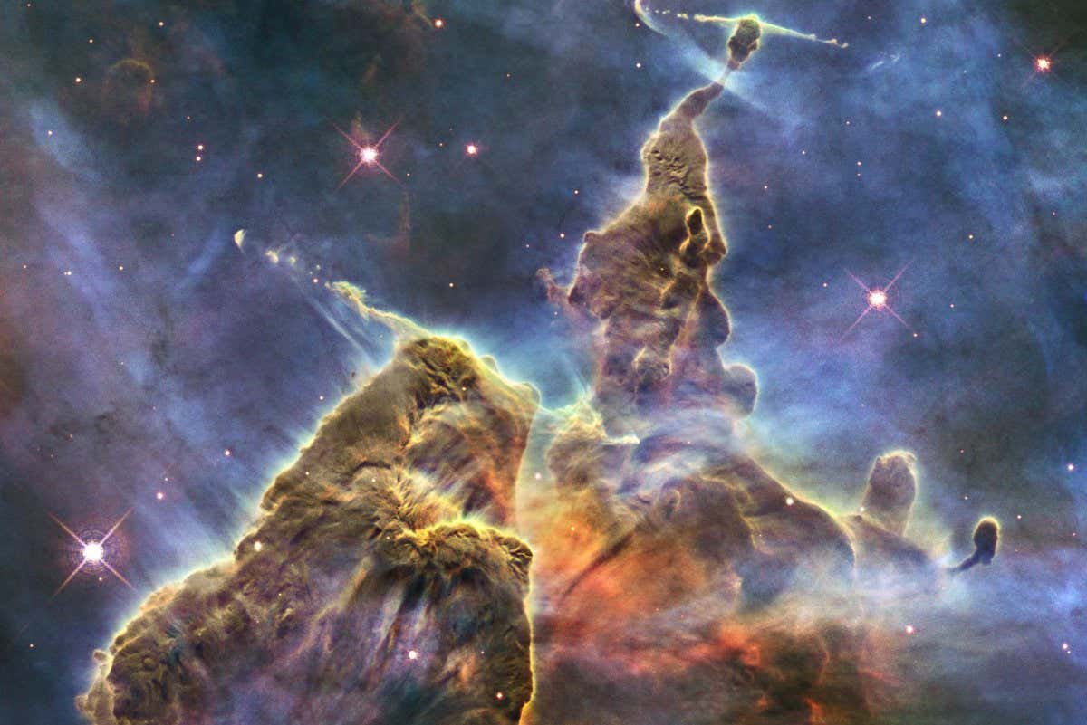 NASA's Hubble Space Telescope captures the chaotic activity atop a three-light-year-tall pillar of gas and dust that is being eaten away by the brilliant light from nearby bright stars in a tempestuous stellar nursery called the Carina Nebula.