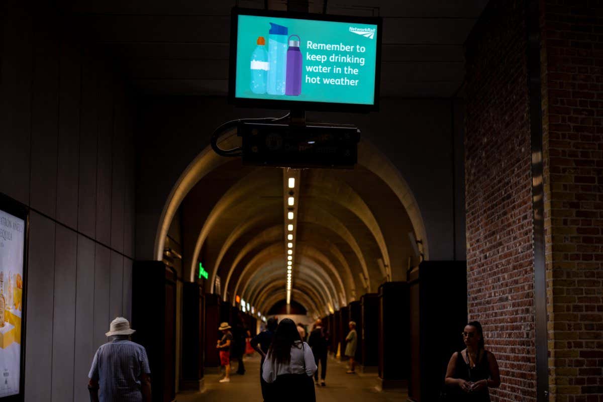A digital sign at London Bridge reminds commuters to keep drinking water during a heatwave in London, UK, on Monday, July 18, 2022. Extreme heat could lead to power outages, canceled flights and may be a danger to life while the so-called Red Extreme warning is in place across parts of southern England on Monday and Tuesday. Photographer: Jose Sarmento Matos/Bloomberg via Getty Images