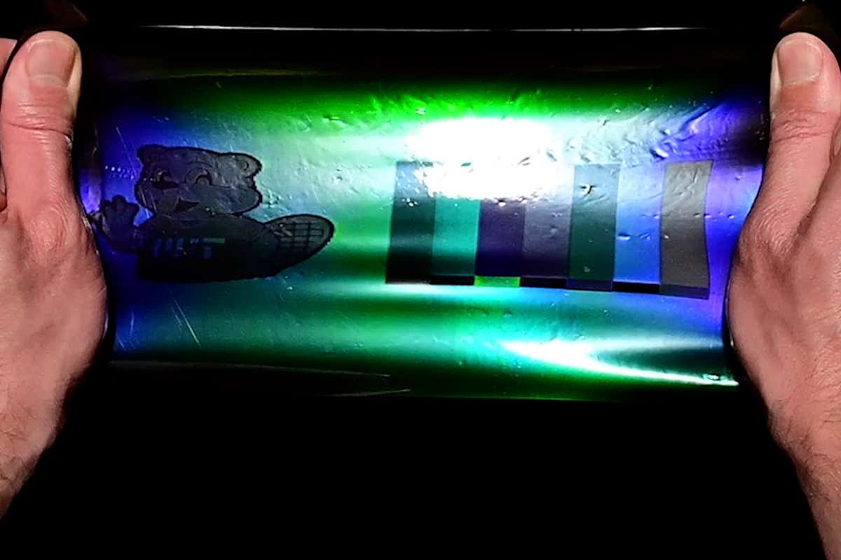 A piece of material is pulled and changes colour