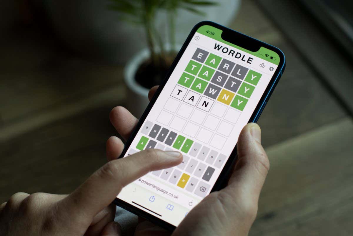 A woman plays Wordle on its official website on her iPhone