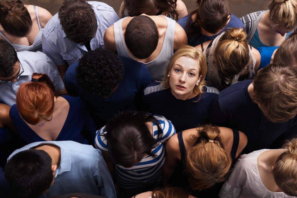 group of people standing very close - one person looking up