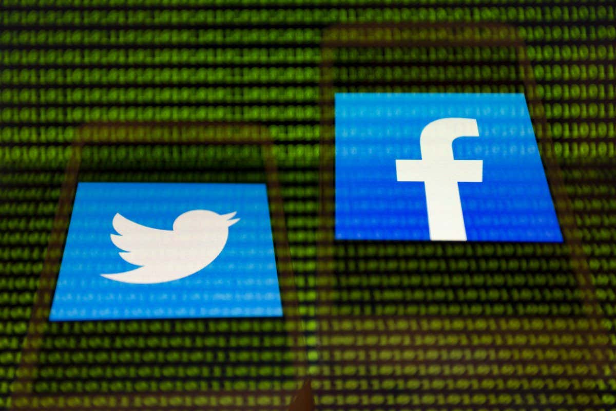 Mandatory Credit: Photo by Andre M Chang/ZUMA Wire/Shutterstock (11726679b) Illustration photo - In-camera multiple exposure image shows apps icons of Twitter and Facebook on smartphone screen in front of binary code digits on display. Twitter and Facebook Apps Icons on Smartphone, Asuncion, Paraguay - 26 Jan 2021