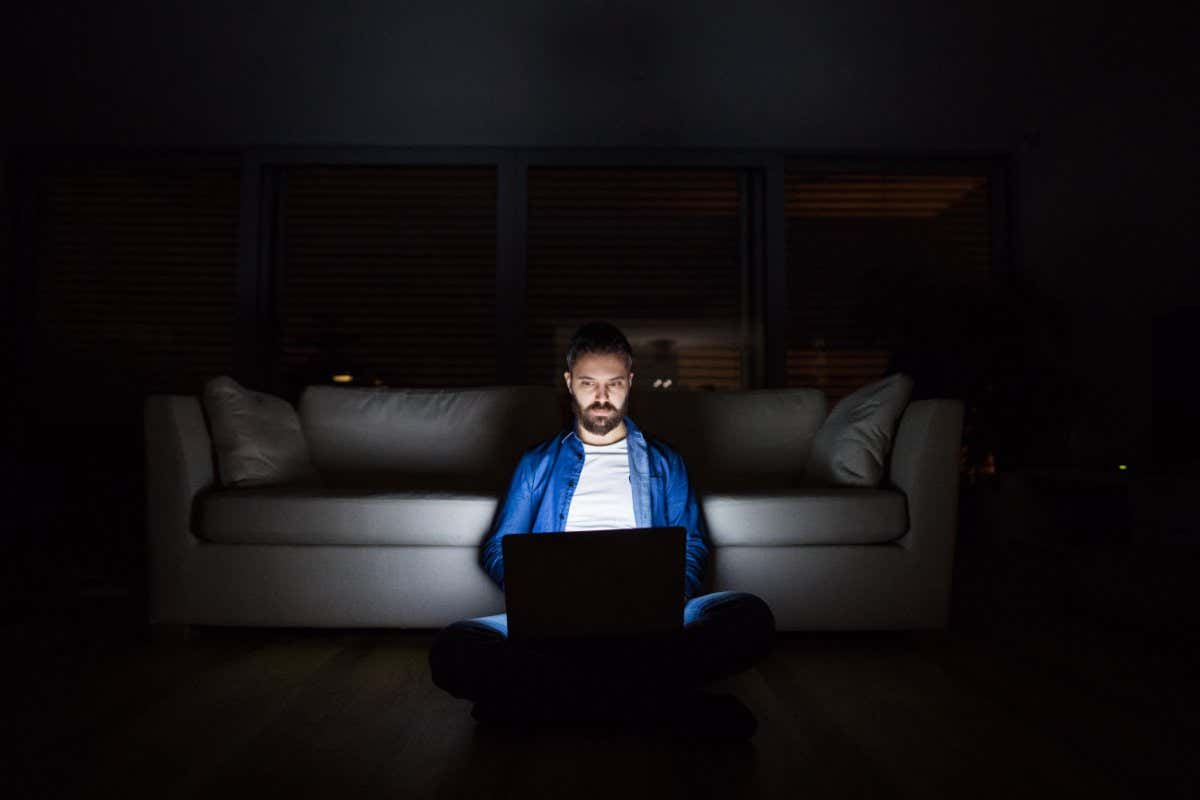 A man working on a laptop at home at night.; Shutterstock ID 1069794632; purchase_order: -; job: -; client: -; other: -