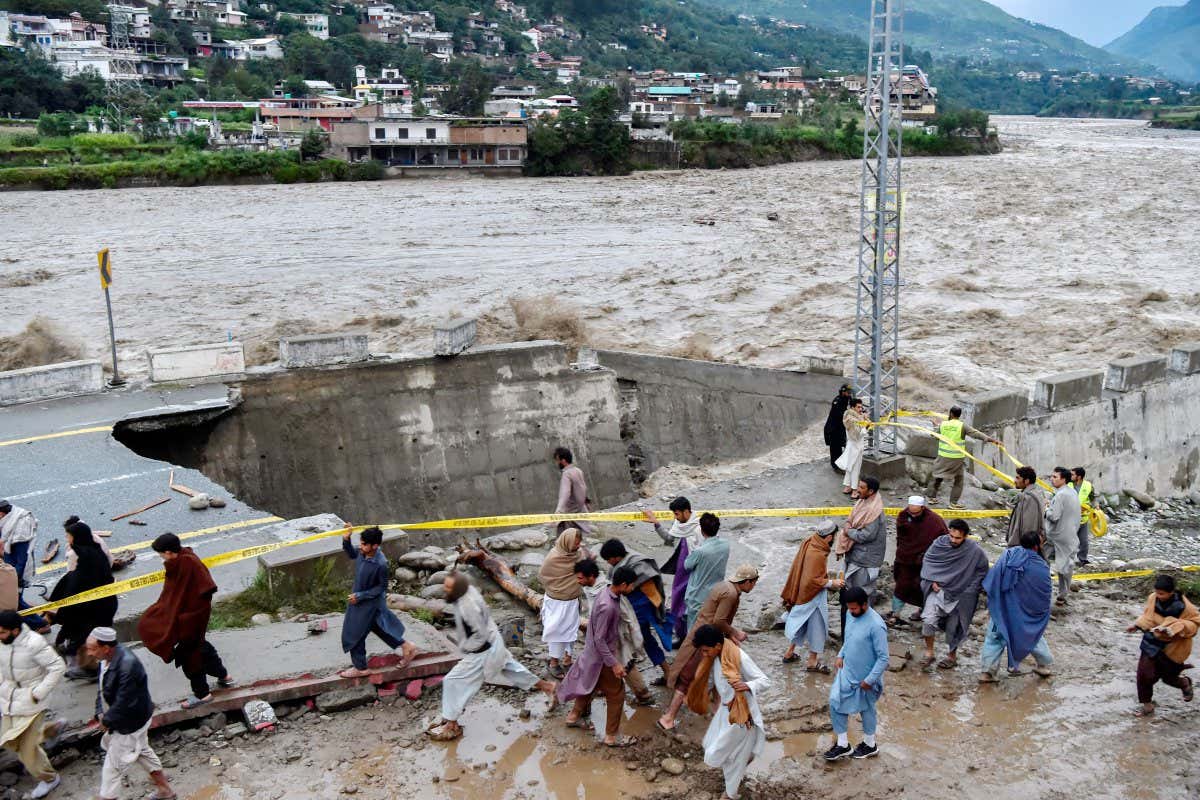 A road damaged by flood waters following heavy monsoon rains in Madian, Pakistan