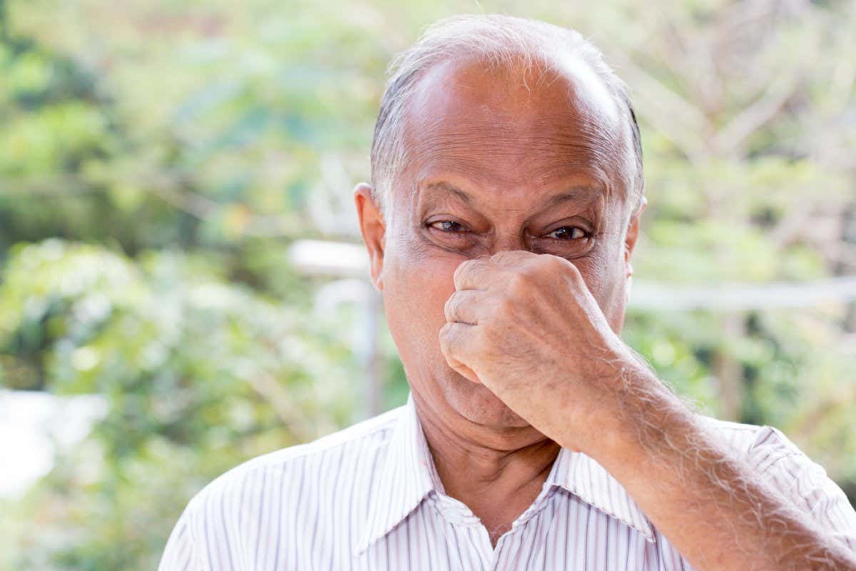 Closeup portrait, senior mature man, disgust face, pinch nose, something stinks, very bad smell, isolated outdoors outside background. Negative emotion, facial expression; Shutterstock ID 640783057; purchase_order: -; job: -; client: -; other: -