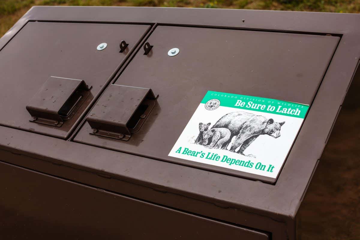 2HCMP5D The top cover of the bear-proof garbage containers along the Lake Estes walkway in Estes Park, Colorado