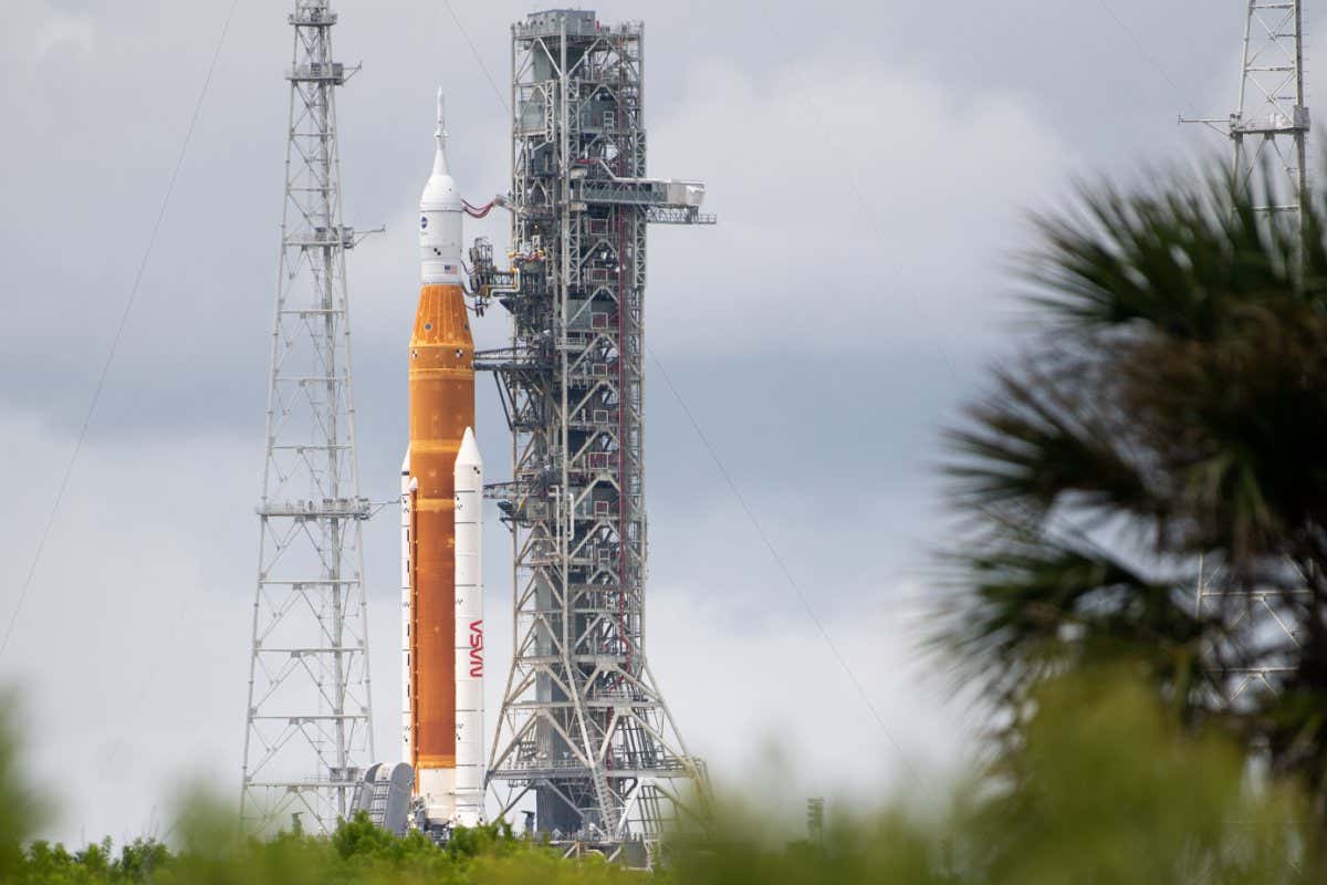 NASA's Space Launch System (SLS) rocket with the Orion spacecraft aboard is seen atop a mobile launcher at Launch Pad 39B as preparations for launch continue, Sunday, Aug. 28, 2022, at NASA's Kennedy Space Center in Florida. NASA's Artemis I flight test is the first integrated test of the agency's deep space exploration systems: the Orion spacecraft, SLS rocket, and supporting ground systems. Launch of the uncrewed flight test is targeted for no earlier than Aug. 29 at 8:33 a.m. ET. Photo Credit: (NASA/Joel Kowsky)