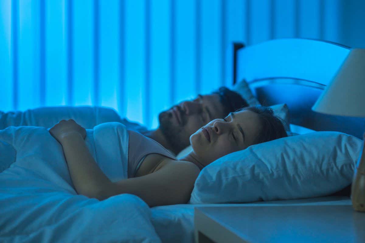A sleeping man and woman in bed