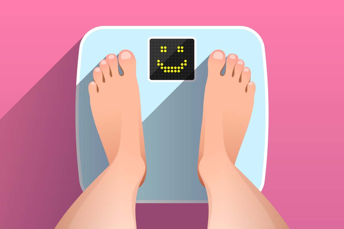 Woman is standing on bathroom scales with happy smiling face on display, over colored background, top view of feet. Weight measurement and control. Concept of healthy lifestyle, dieting and fitness