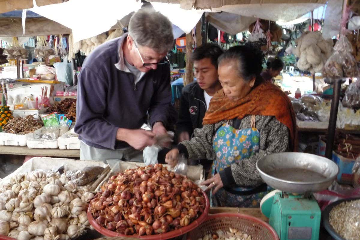 Adam buying seed Luang Prabang market