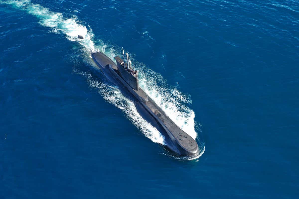 Aerial drone photo of latest technology navy armed diesel powered submarine cruising half submerged deep blue sea; Shutterstock ID 1894295101; purchase_order: -; job: -; client: -; other: -